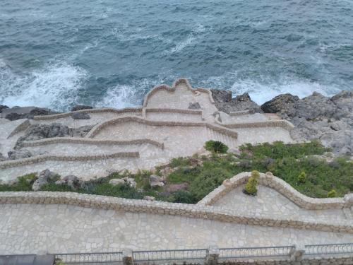 a staircase leading to the ocean with the waves at Apartment Sea Space 2 in Dobra Voda