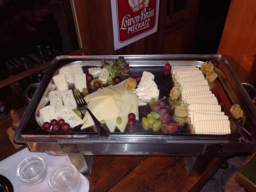a tray of cheese and other foods on a table at Alte Schreinerei-Auberge Harlekin in Singen