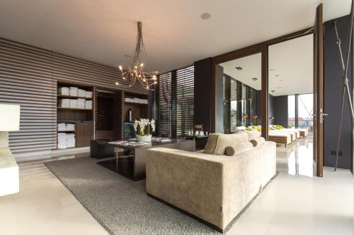a living room with a couch and a table at SAKS Urban Design Hotel Kaiserslautern in Kaiserslautern