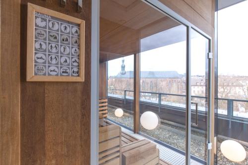a room with a view of the city seen through windows at SAKS Urban Design Hotel Kaiserslautern in Kaiserslautern