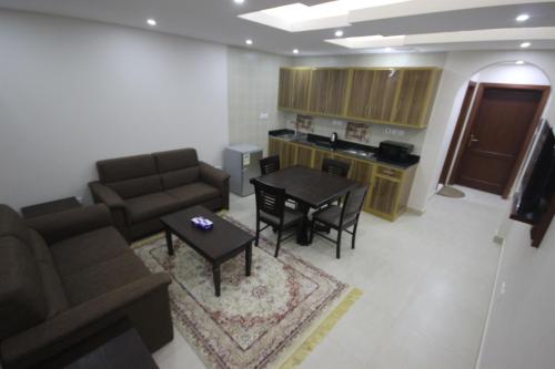 a living room with a couch and a table at Jana Palace Serviced Apartments in Jeddah