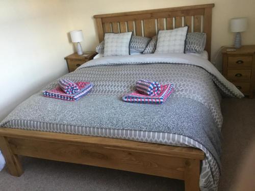 a bedroom with a bed with two pillows on it at Mount Pleasant Apartments in Beaumaris