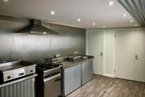 a kitchen with a stove and a stove top oven at Lagan Backpackers in Belfast