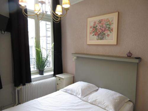 Ein Bett oder Betten in einem Zimmer der Unterkunft Hotel Notre Dame