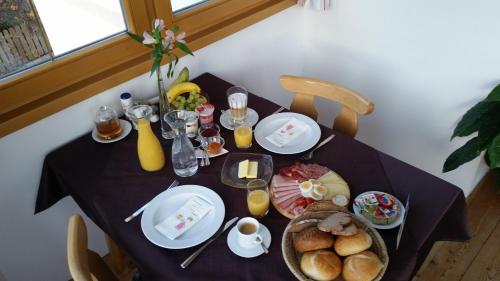 a table with plates of food on top of it at Haus Arnold - Privatzimmer und Ferienwohnungen in Sillian
