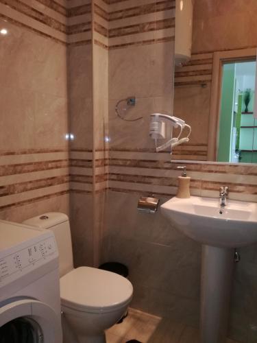 a bathroom with a toilet and a sink at Apartment Sea Space 3 in Dobra Voda
