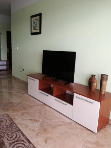 a flat screen tv sitting on top of a white entertainment center at Apartment Sea Space 3 in Dobra Voda