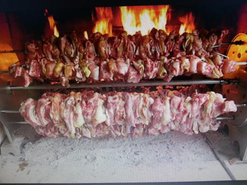 a bunch of meat being cooked in an oven at Ristoro Saint Roch in Hone