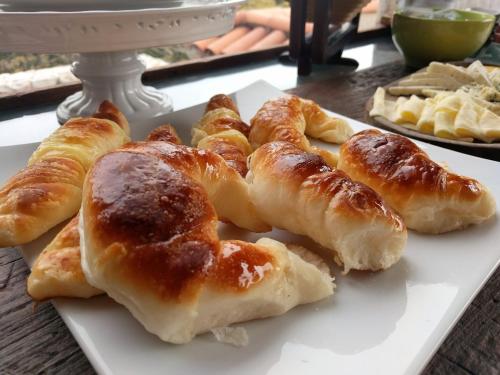 a white plate with croissants on a table at Kkala Boutique Hotel in Salta