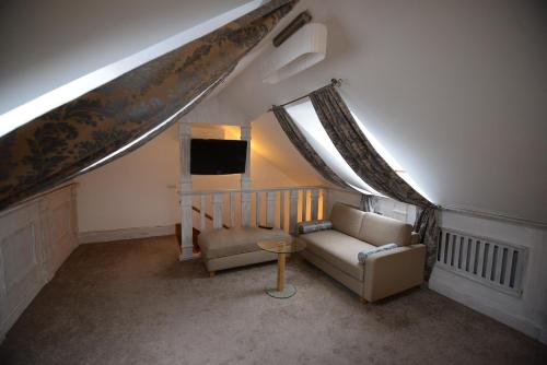 a living room with a couch and a tv at Pidkova in Rivne