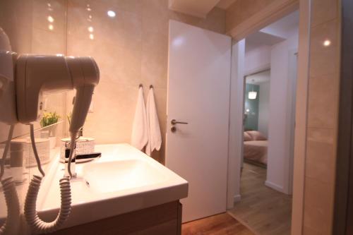 a bathroom with a sink and a phone at Alfama Right Point in Lisbon