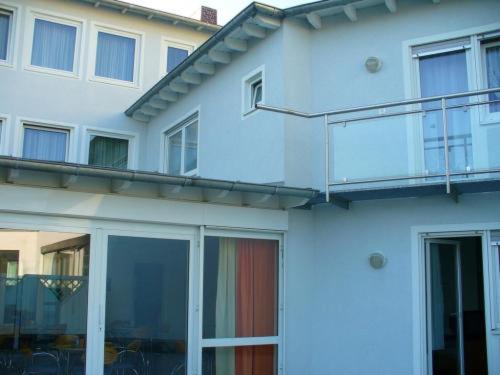 a white building with a balcony on the side of it at Hotel Ernst Ludwig in Darmstadt
