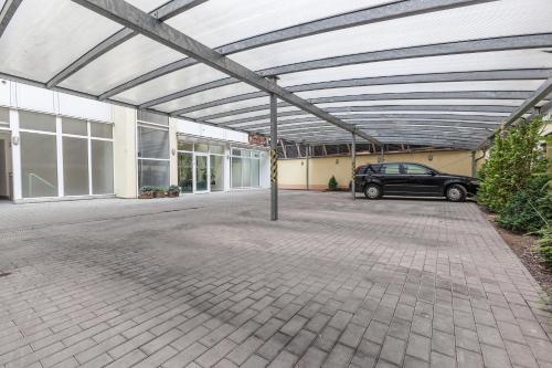 a parking lot with a car parked in a garage at Augustus et Otto Hotel in Prague