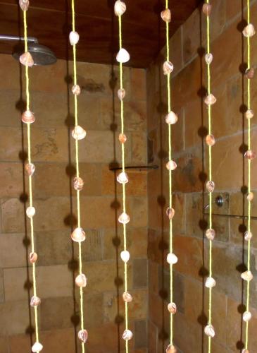 a string of lights hanging from a wall at Casa na Praia de Muriu - Andréia in Muriú