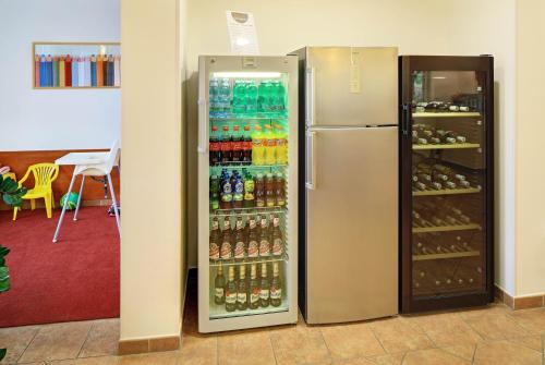 a refrigerator filled with lots of bottles of soda at Penzion Krumlov - Massage studio in Český Krumlov