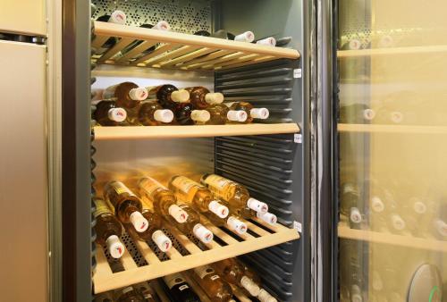 a refrigerator filled with lots of bottles of wine at Penzion Krumlov - Massage studio in Český Krumlov