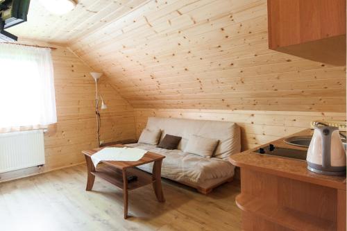 a room with a bed and a table in a cabin at Ośrodek Wypoczynkowy "u Krzysia" in Ustroń