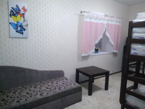 a living room with a couch and a table at Parasolka in Luts'k