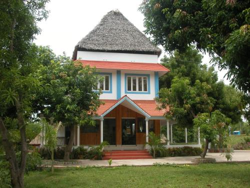 a small house with a gambrel roof at Prince Park in Puducherry