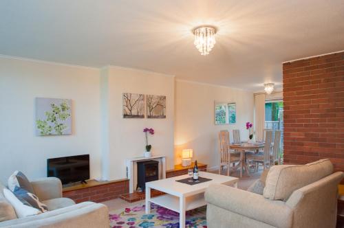 a living room with two chairs and a fireplace at MyCityHaven - The Chippings - Village life in the city in Bristol