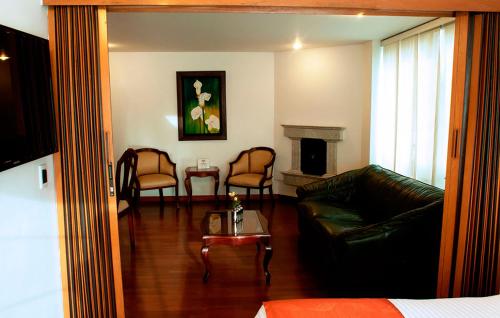 a living room with a couch and a fireplace at Apartaestudios Los Andes in Bogotá