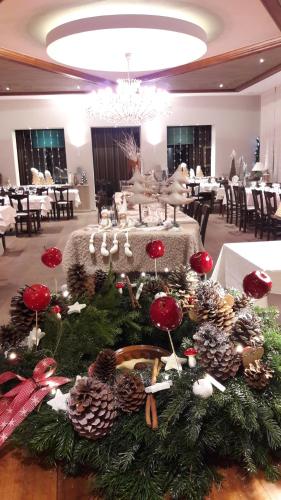 a room with a table with christmas decorations on it at Hotel Restaurant Beau Séjour in Morsbronn-les-Bains