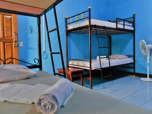 a bedroom with two bunk beds and a chair at Hostal Siero in Moyogalpa