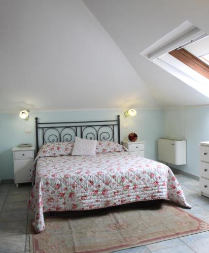a white bedroom with a bed with a red bedspread at Hotel La Torre in Rimini