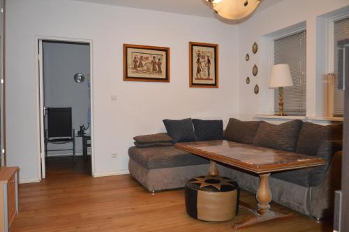 a living room with a couch and a table at BS Business Travelling Hannover City in Hannover