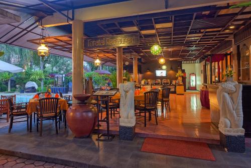 a dining room with tables and chairs in a restaurant at Hotel Montana Dua Malang in Malang