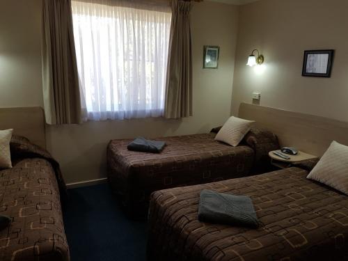 Ένα ή περισσότερα κρεβάτια σε δωμάτιο στο Abraham Lincoln Motel