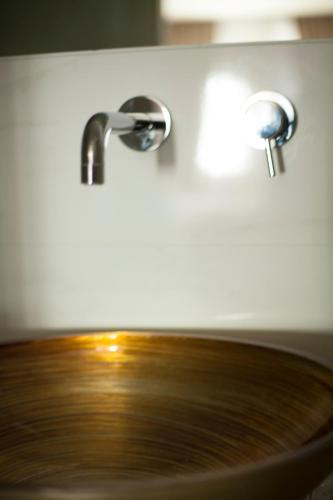 a wooden sink with a faucet in a bathroom at Arcadia Boutique Hotel in Venice