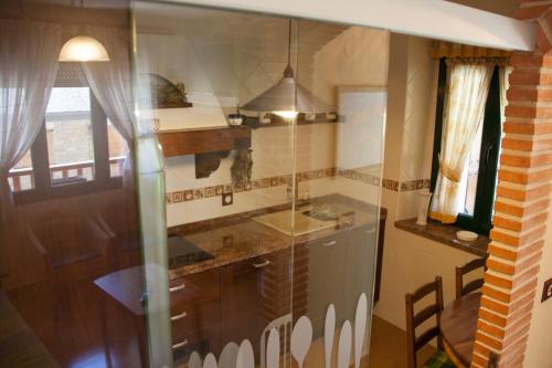 a kitchen with a sink and a counter top at Hostal El Recanto in Vega de Valcarce