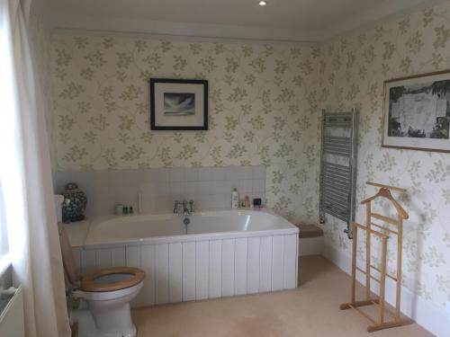 a bathroom with a tub and a toilet and a sink at Waldegrave farm in Hartest