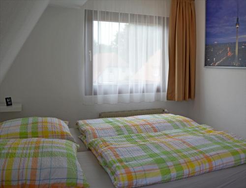 Кровать или кровати в номере Ferienwohnung Teltow 2
