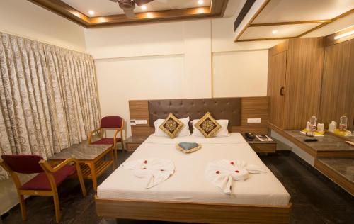 a hotel room with a bed with towels on it at Sri Janakiram Hotels in Tirunelveli