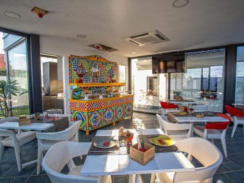 a restaurant with tables and chairs and a dj at Tra Le Braccia di Morfeo in Terrasini