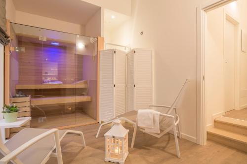 a room with a chair and a table and a window at Palazzo Monga Boutique Guesthouse in Verona