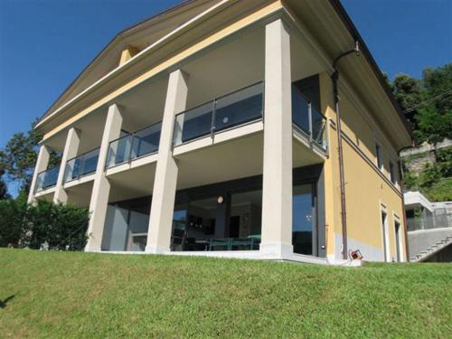 a large building with large windows on top of a hill at Appartamento Cicci Bello in Ghiffa