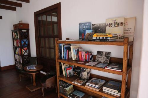 a book shelf filled with books and other books at Hotel Boutique Palacio Ico - Only Adults in Teguise