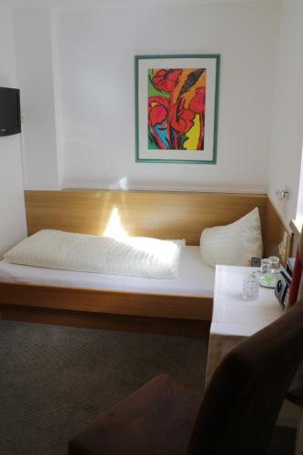 a bed in a room with a picture on the wall at Ferienwohnung Saunahaus in Annaberg im Lammertal