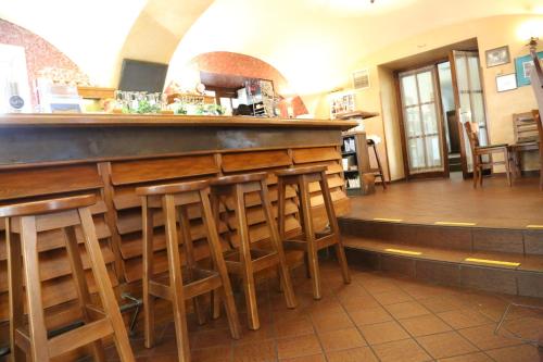 
a kitchen filled with wooden tables and chairs at Babenbergerhof in Ybbs an der Donau
