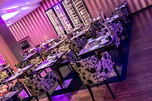 a group of tables in a room with purple lighting at Schlosshotel Kassel in Kassel