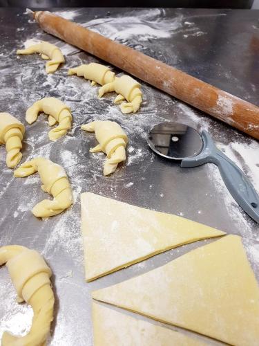 a bunch of uncooked dough on a table with a measuring spoon at Hotel Aurora Duino in Duino