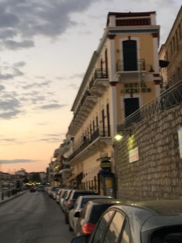 a row of cars parked on a street next to a building at Aktaion City Hotel in Gythio