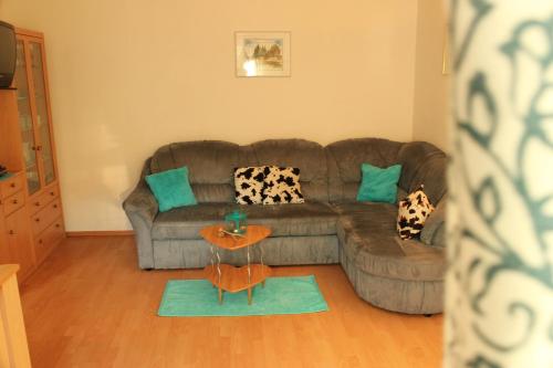 a living room with a couch and a table at Ferienhof Kreilgut in Rossleithen