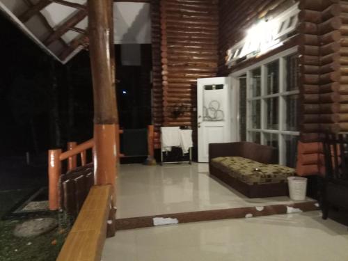 a living room with a couch and a table at Vila Kota Bunga Private Pool in Puncak