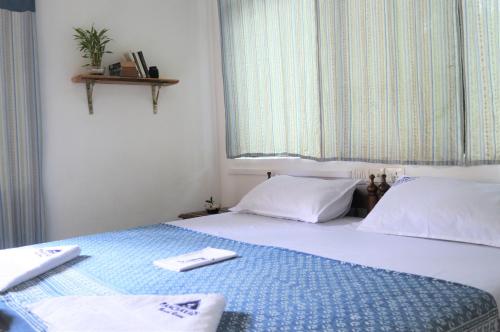 a bedroom with a bed with two towels on it at Panchavadi Ayurvedic Beach Resort in Varkala