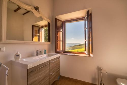 a bathroom with a sink and a window at Fattoria Poggerino in Radda in Chianti
