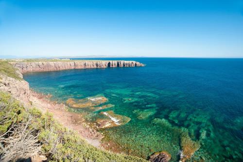 an aerial view of a beach and the ocean at Lu' Hotel Riviera - Carloforte in Carloforte